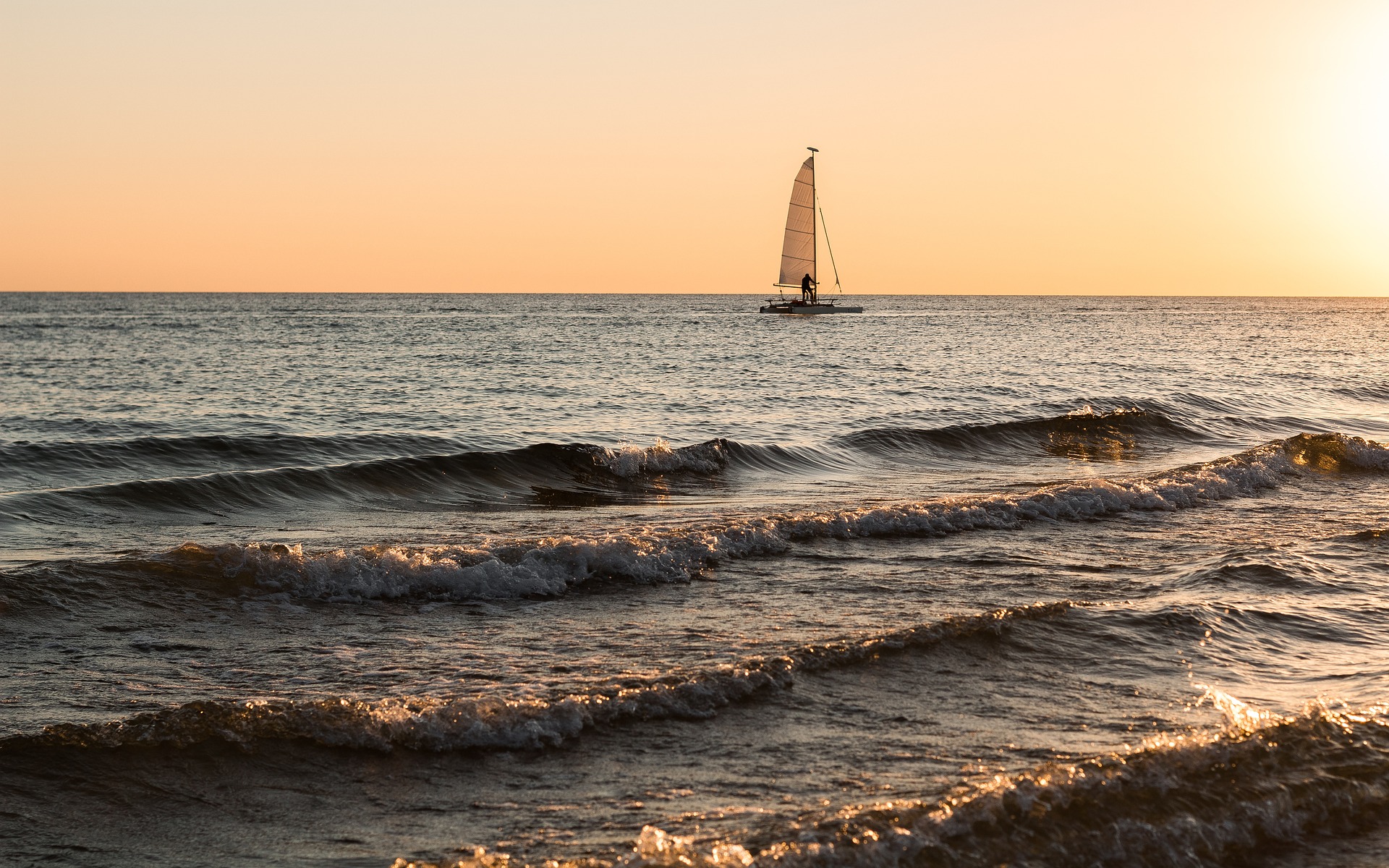 Sail boat sailing near Barceloneta beach during AMERICA'S CUP